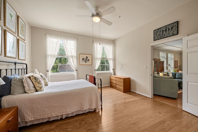 2305 Worthington St Unit 328, Dallas, TX 75204 - bedroom with light wood-type flooring, baseboards, and ceiling fan