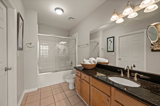2305 Worthington St Unit 328, Dallas, TX 75204 - bathroom featuring tile patterned flooring, toilet, vanity, combined bath / shower with glass door, and baseboards