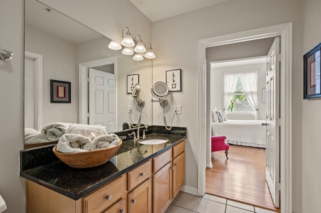 2305 Worthington St Unit 328, Dallas, TX 75204 - bathroom featuring vanity, tile patterned flooring, a chandelier, and ensuite bathroom