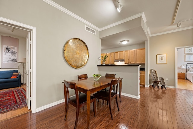 2305 Worthington St Unit 328, Dallas, TX 75204 - dining space with track lighting, dark wood-type flooring, ornamental molding, and baseboards