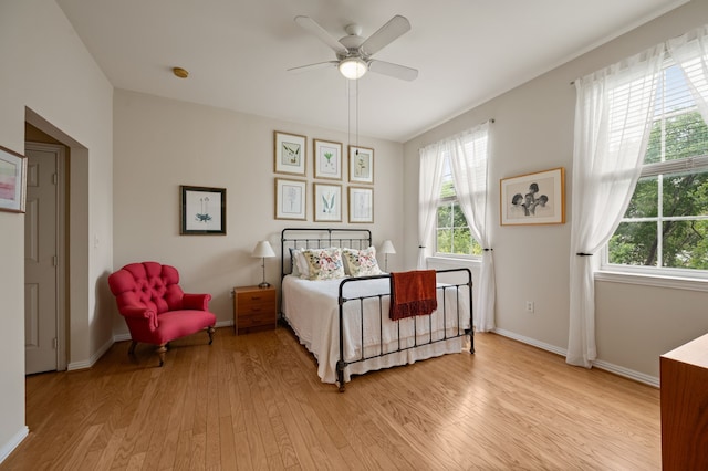 2305 Worthington St Unit 328, Dallas, TX 75204 - bedroom featuring light wood finished floors, multiple windows, baseboards, and a ceiling fan
