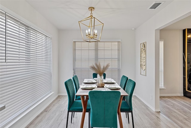 1427 Northridge Dr, Carrollton, TX 75006 - dining area featuring a chandelier, light wood finished floors, and baseboards