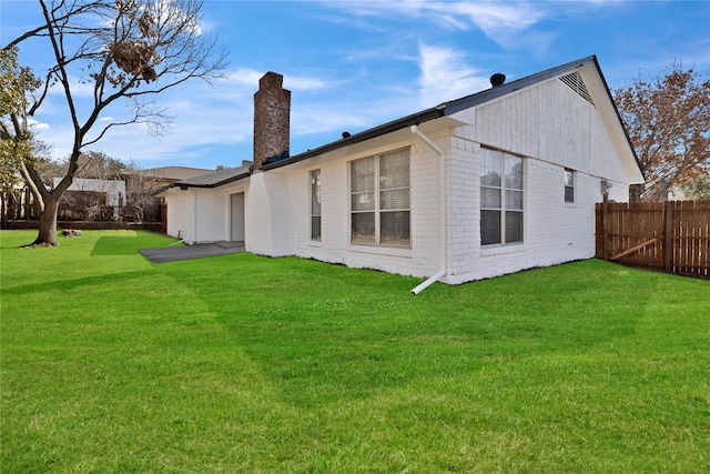 1427 Northridge Dr, Carrollton, TX 75006 - back of house with a chimney and brick siding