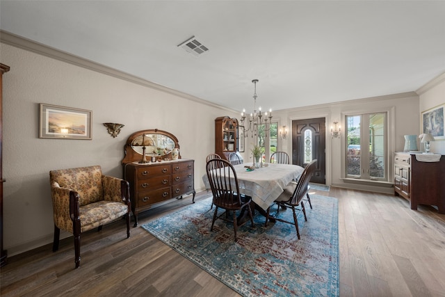 3417 Fern Hill Cir, Waco, TX 76708 - dining area with ornamental molding, a chandelier, and wood finished floors