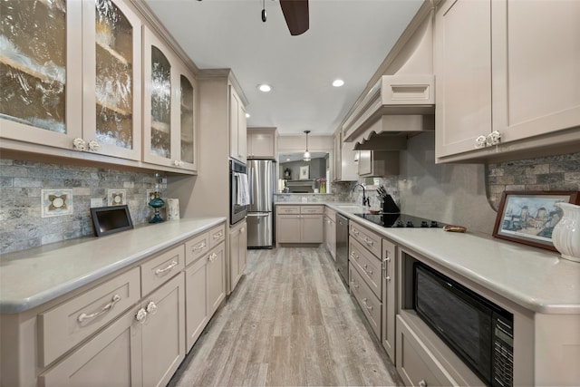 3417 Fern Hill Cir, Waco, TX 76708 - kitchen with black appliances, decorative backsplash, light wood finished floors, a sink, and a ceiling fan