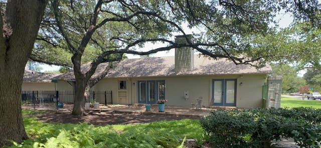 3417 Fern Hill Cir, Waco, TX 76708 - back of house featuring french doors and a chimney