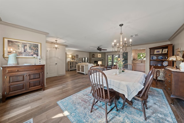 3417 Fern Hill Cir, Waco, TX 76708 - dining space featuring a chandelier, ornamental molding, light wood-type flooring, and a ceiling fan