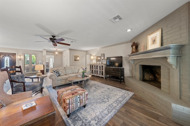 3417 Fern Hill Cir, Waco, TX 76708 - living room with wood finished floors, a brick fireplace, a ceiling fan, and ornamental molding