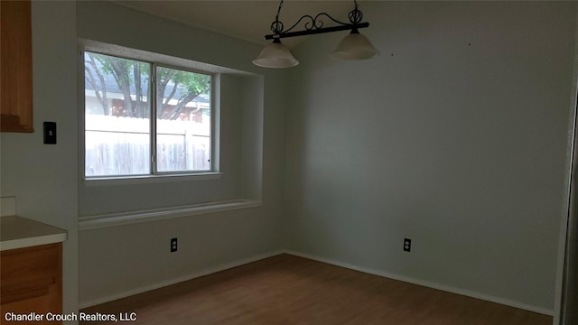 741 Cardinal Dr, Saginaw, TX 76131 - unfurnished dining area with wood finished floors, healthy amount of natural light, and baseboards
