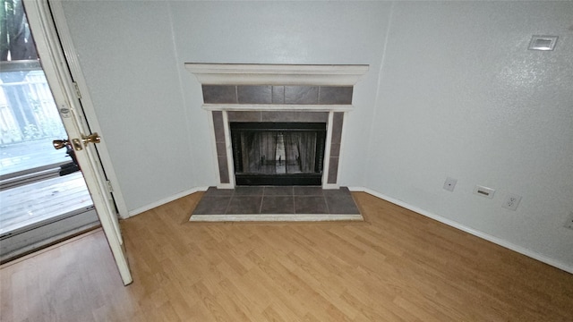 741 Cardinal Dr, Saginaw, TX 76131 - detailed view of wood finished floors, baseboards, and a tile fireplace