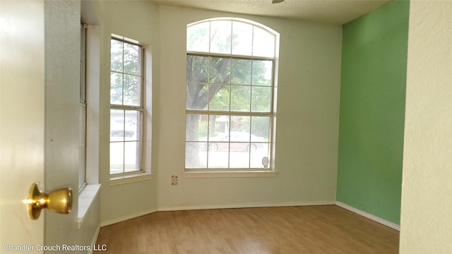 741 Cardinal Dr, Saginaw, TX 76131 - unfurnished room with wood finished floors, healthy amount of natural light, and baseboards
