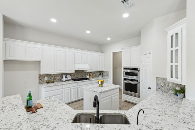 106 Morning Star Trl, Aurora, TX 76078 - kitchen with a sink, light stone counters, backsplash, under cabinet range hood, and white cabinetry