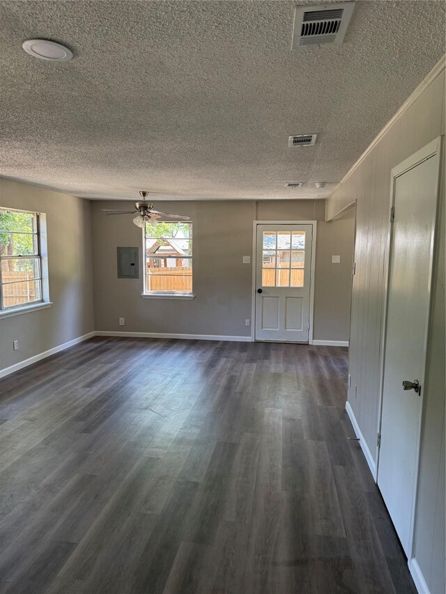 405 Forest Ln, Gun Barrel City, TX 75156 - spare room featuring a textured ceiling, healthy amount of natural light, dark wood-style floors, electric panel, and a ceiling fan