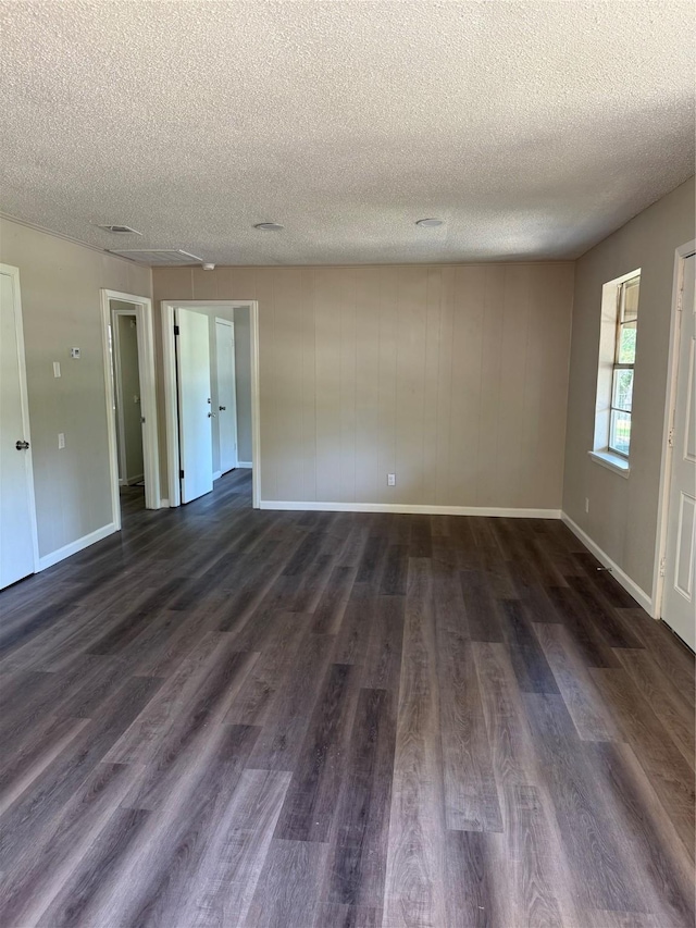 405 Forest Ln, Gun Barrel City, TX 75156 - spare room with a textured ceiling, dark wood finished floors, and baseboards
