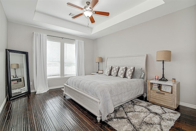 2420 Poplar Spring Rd, Fort Worth, TX 76123 - bedroom featuring a tray ceiling, baseboards, dark wood-style flooring, and a ceiling fan