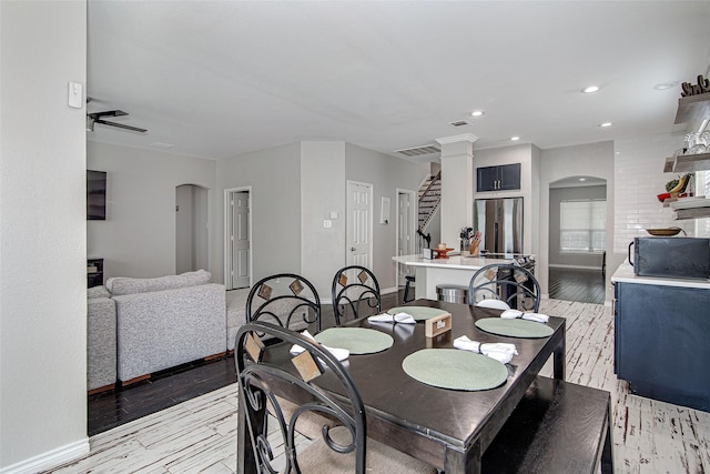 2420 Poplar Spring Rd, Fort Worth, TX 76123 - dining space featuring arched walkways, baseboards, stairs, light wood finished floors, and recessed lighting