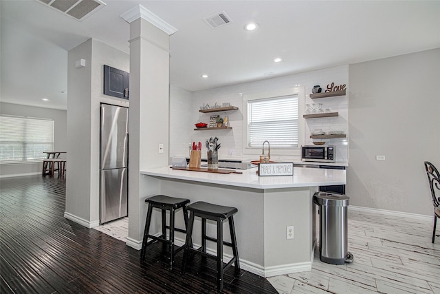 2420 Poplar Spring Rd, Fort Worth, TX 76123 - kitchen with stainless steel appliances, open shelves, a breakfast bar, healthy amount of natural light, and recessed lighting