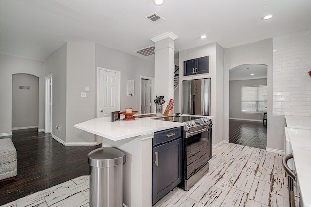 2420 Poplar Spring Rd, Fort Worth, TX 76123 - kitchen with appliances with stainless steel finishes, arched walkways, light wood-style floors, light countertops, and baseboards