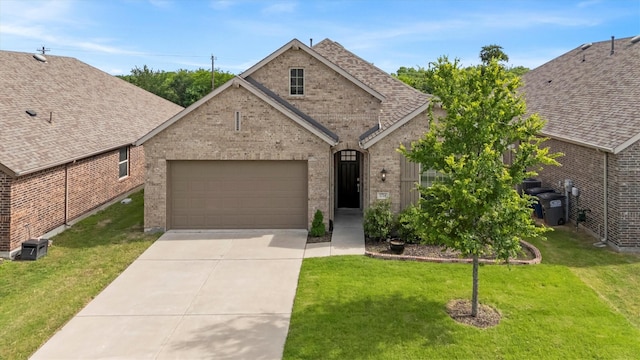1714 Lone Lynx Way, Wylie, TX 75098 - view of front facade with brick siding, a garage, driveway, a front yard, and roof with shingles