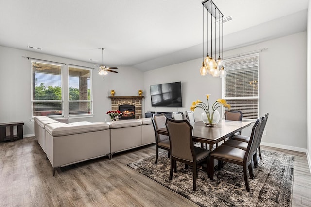 1714 Lone Lynx Way, Wylie, TX 75098 - dining space with a ceiling fan, wood finished floors, a fireplace, and baseboards