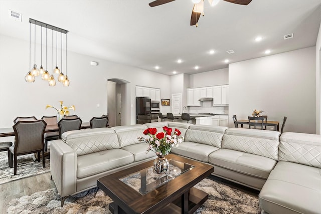 1714 Lone Lynx Way, Wylie, TX 75098 - living area with arched walkways, light wood-type flooring, ceiling fan, and recessed lighting