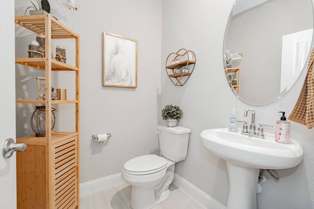 223 Quarry St, Melissa, TX 75454 - bathroom featuring toilet, baseboards, and a sink