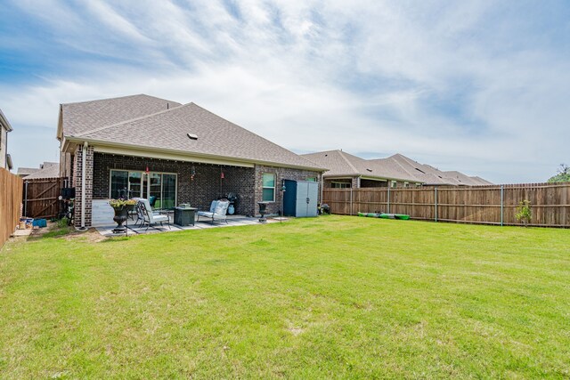 223 Quarry St, Melissa, TX 75454 - rear view of property with a patio area, brick siding, roof with shingles, and a fire pit