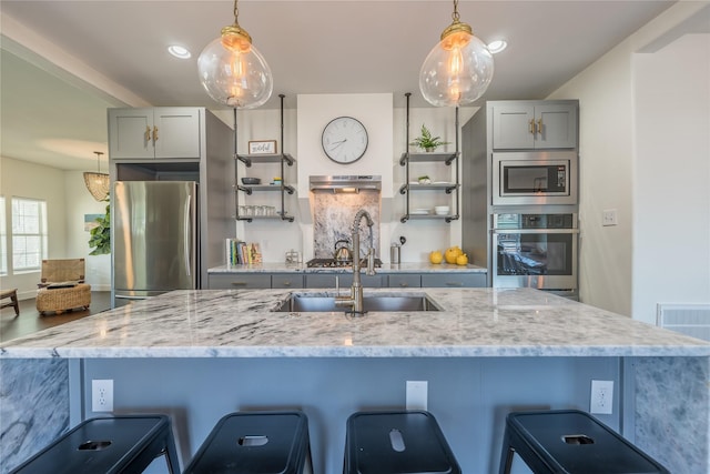 2025 Columbus Ave, Waco, TX 76701 - kitchen with stainless steel appliances, gray cabinetry, open shelves, a sink, and recessed lighting