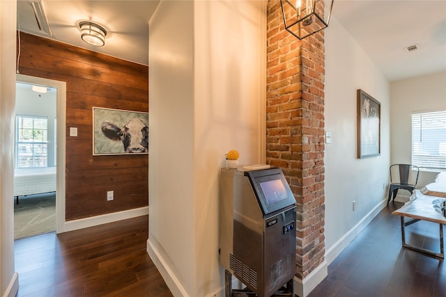 2025 Columbus Ave, Waco, TX 76701 - hallway with dark wood-style flooring, wooden walls, and baseboards