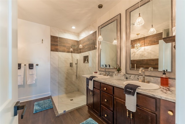 2025 Columbus Ave, Waco, TX 76701 - bathroom with walk in shower, wood finished floors, double vanity, and baseboards