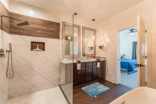 2025 Columbus Ave, Waco, TX 76701 - full bath featuring vanity, a walk in shower, wood finished floors, and a ceiling fan