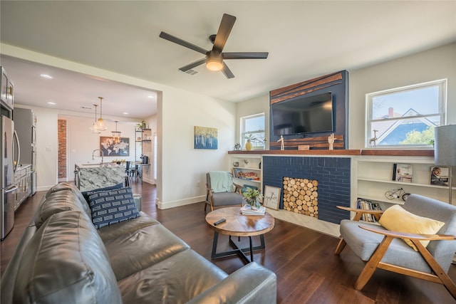 2025 Columbus Ave, Waco, TX 76701 - living area with a ceiling fan, dark wood-type flooring, a fireplace, recessed lighting, and baseboards