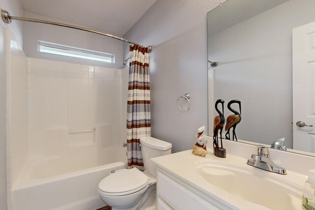 8614 Granville Dr, Dallas, TX 75249 - full bathroom featuring toilet, shower / bathtub combination with curtain, and vanity