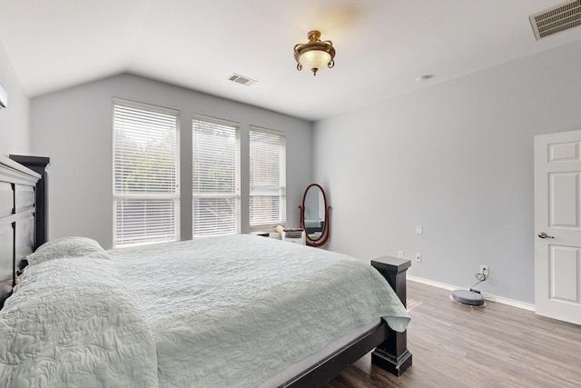8614 Granville Dr, Dallas, TX 75249 - bedroom featuring wood finished floors, baseboards, and vaulted ceiling