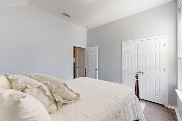 8614 Granville Dr, Dallas, TX 75249 - bedroom with vaulted ceiling, a closet, wood finished floors, and baseboards