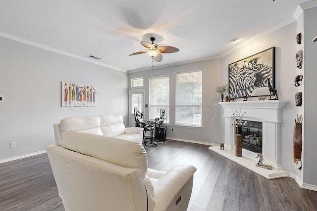 8614 Granville Dr, Dallas, TX 75249 - living area featuring a ceiling fan, dark wood-type flooring, a fireplace with raised hearth, ornamental molding, and baseboards