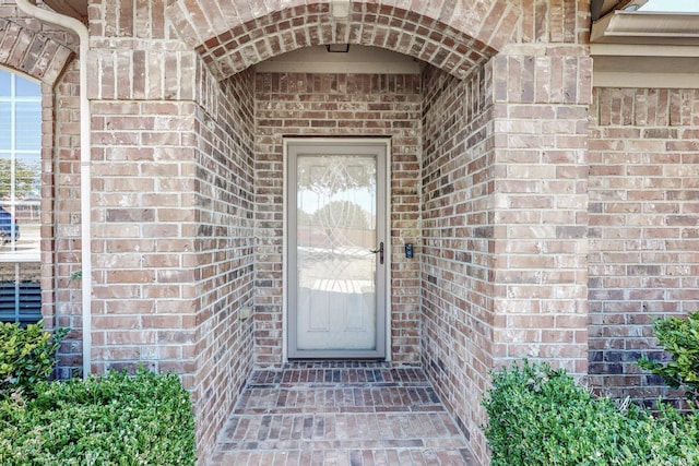 8614 Granville Dr, Dallas, TX 75249 - doorway to property featuring brick siding