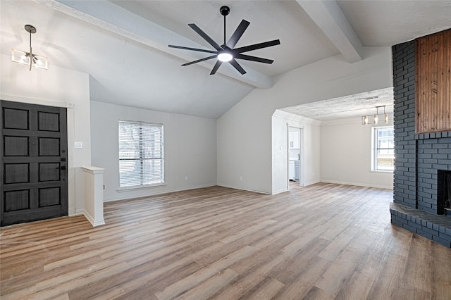 3229 Poteet Dr, Mesquite, TX 75150 - unfurnished living room featuring light wood-style floors, a fireplace, ceiling fan, baseboards, and a chandelier