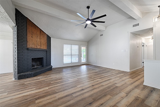 3229 Poteet Dr, Mesquite, TX 75150 - unfurnished living room with a ceiling fan, a fireplace, wood finished floors, a textured ceiling, and baseboards