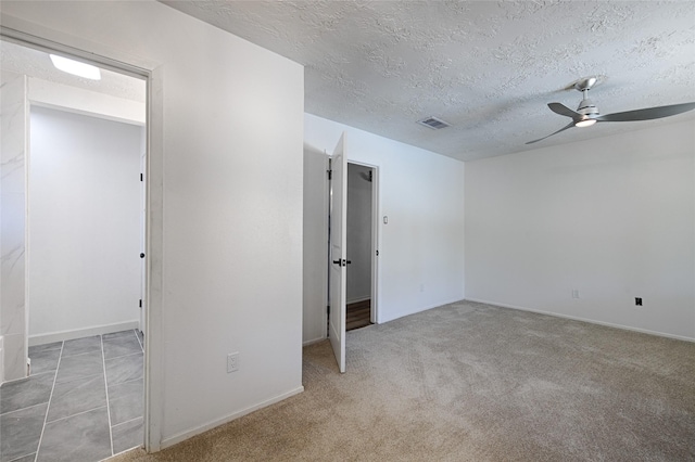 3229 Poteet Dr, Mesquite, TX 75150 - unfurnished bedroom featuring a textured ceiling, carpet flooring, baseboards, and a ceiling fan