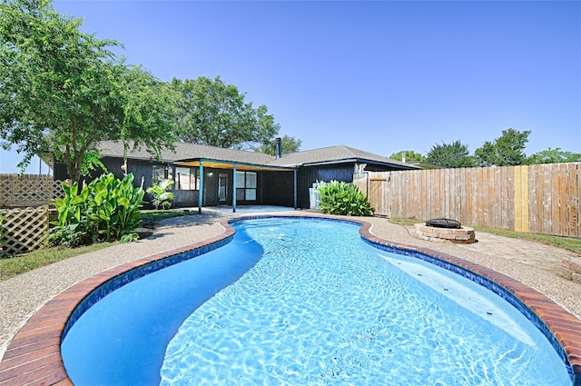3229 Poteet Dr, Mesquite, TX 75150 - view of swimming pool featuring an outdoor fire pit, a fenced backyard, and a patio