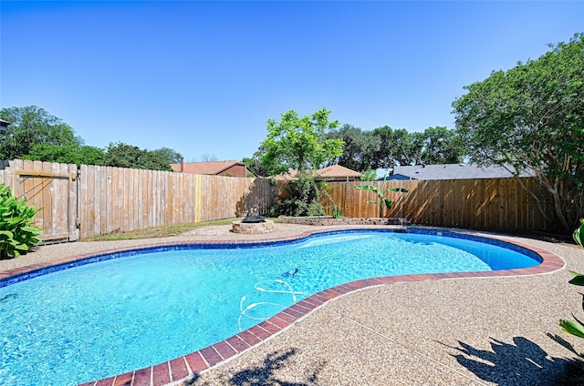 3229 Poteet Dr, Mesquite, TX 75150 - view of swimming pool with an outdoor fire pit and a fenced backyard