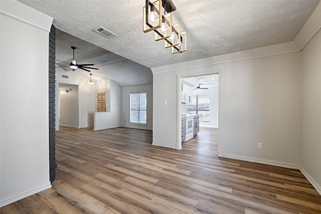 3229 Poteet Dr, Mesquite, TX 75150 - unfurnished room featuring vaulted ceiling, wood finished floors, ceiling fan, baseboards, and a textured ceiling