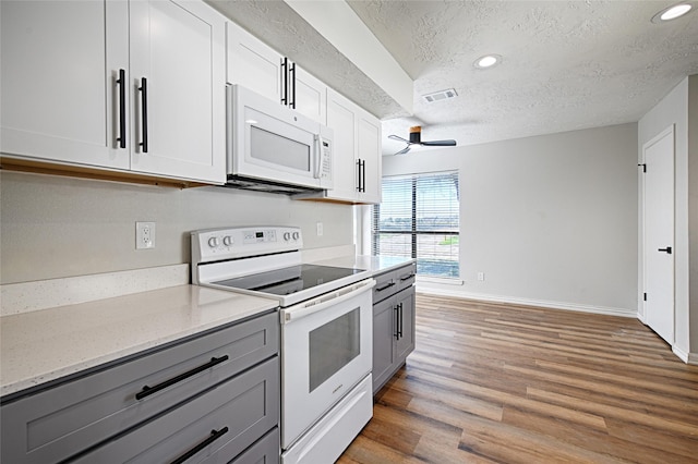3229 Poteet Dr, Mesquite, TX 75150 - kitchen with white appliances, gray cabinets, a textured ceiling, ceiling fan, and light wood-style floors