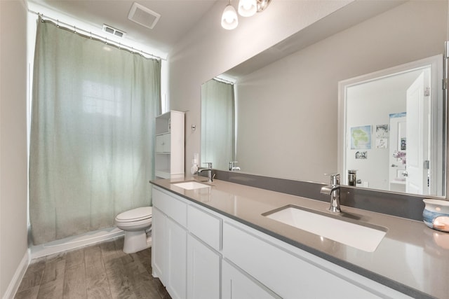6005 Loving Ct, Midlothian, TX 76065 - bathroom with wood finished floors, toilet, double vanity, and a shower with curtain