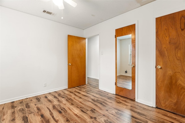 1019 E Elm St, Hillsboro, TX 76645 - unfurnished bedroom featuring wood finished floors, baseboards, and a ceiling fan