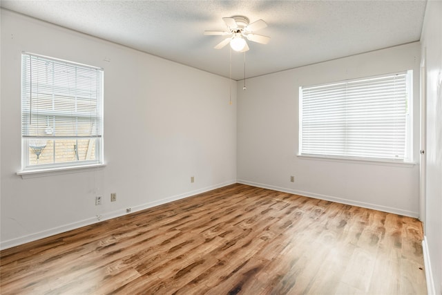 1019 E Elm St, Hillsboro, TX 76645 - spare room featuring light wood-type flooring, ceiling fan, a textured ceiling, and baseboards