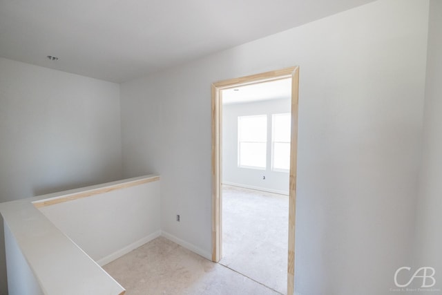 409 Garvin St, Eastland, TX 76448 - hallway featuring baseboards and light colored carpet