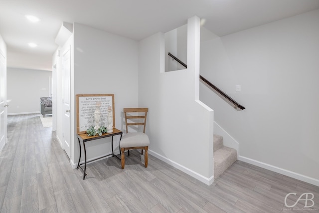 409 Garvin St, Eastland, TX 76448 - corridor featuring wood finished floors, baseboards, and stairway