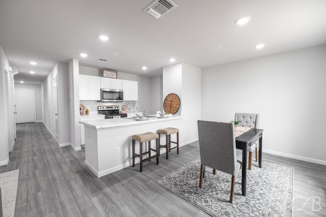 409 Garvin St, Eastland, TX 76448 - dining space featuring baseboards, recessed lighting, and dark wood-style floors